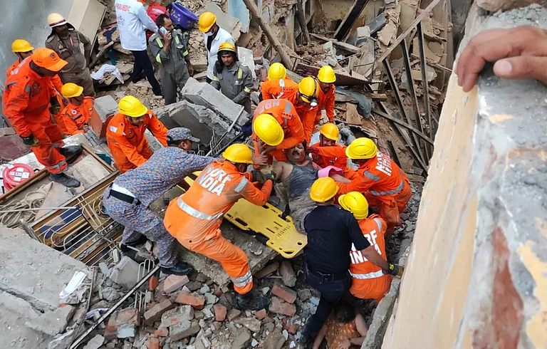 NDRF personnel carry out rescue work after two houses collapsed near the Kashi Vishwanath temple, in Varanasi, Tuesday, Aug. 6, 2024. A woman died in the mishap - PTI